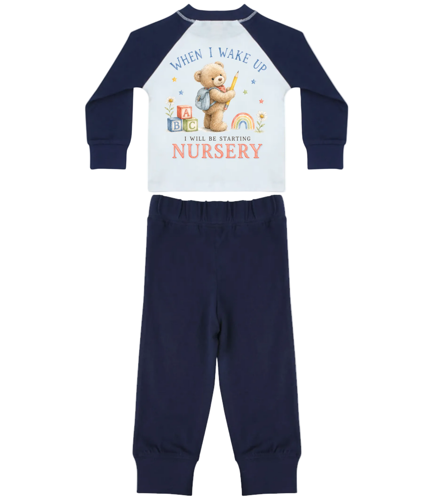 A two-piece baby pajama set featuring a long-sleeve top with a white front and navy blue raglan sleeves, printed with a teddy bear and the text 'WHEN I WAKE UP I WILL BE STARTING NURSERY', paired with matching navy blue pants.